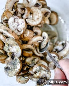 Perfect Roasted Mushrooms With Flavor Twists 5 mixing mushrooms and seasonings in a white bowl