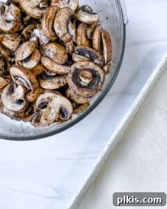 mushrooms thoroughly mixed with spices in a white bowl
