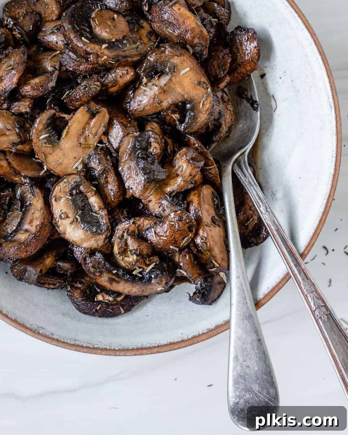 final serving of simple roasted mushrooms on a white plate
