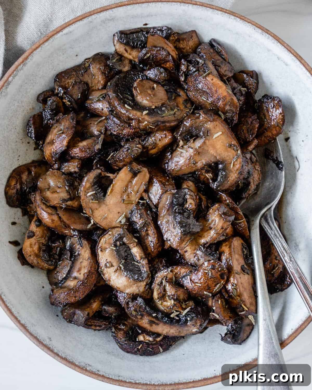 close-up of perfectly roasted mushrooms on a white plate