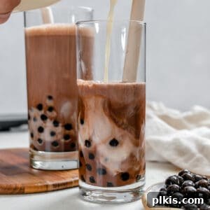 Two glasses of completed Chocolate Milk Tea with boba.