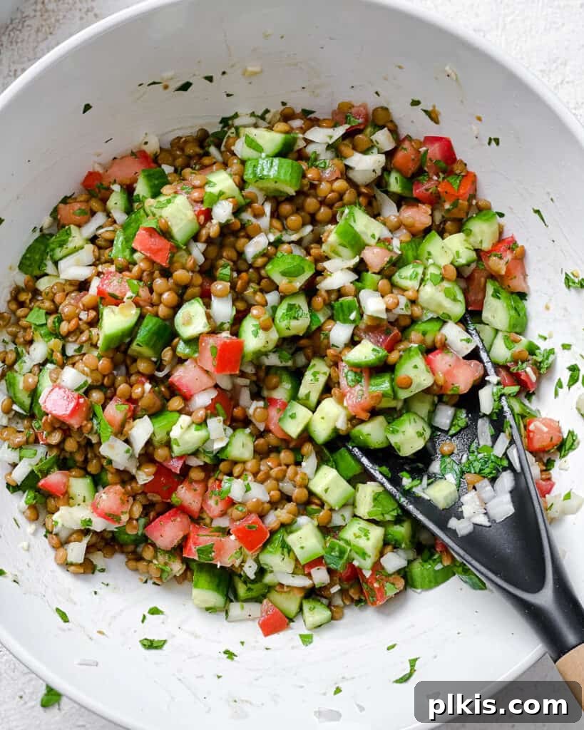Fresh and Flavorful Lentil Tabbouleh 13 Process shot showing the thorough mixing of all ingredients in the bowl.