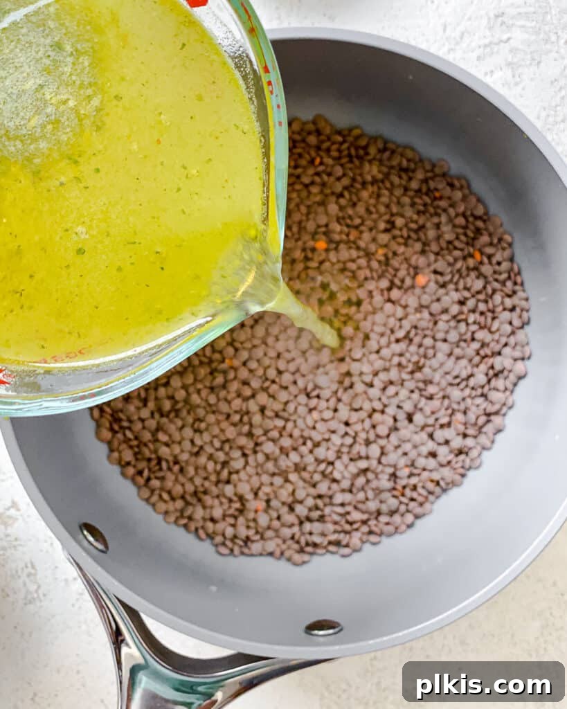 Fresh and Flavorful Lentil Tabbouleh 4 Process shot of adding lemon mixture to lentils in a bowl.