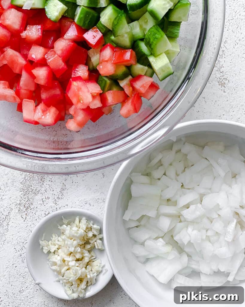Fresh and Flavorful Lentil Tabbouleh 9 Process shot of adding fresh vegetables to a bowl for the tabbouleh.