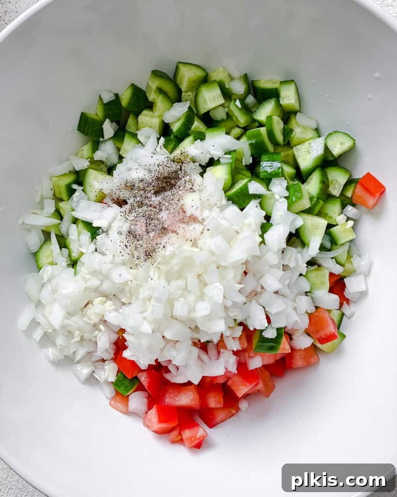 Fresh and Flavorful Lentil Tabbouleh 10 Mixed diced vegetables in a white bowl, ready for the next step.