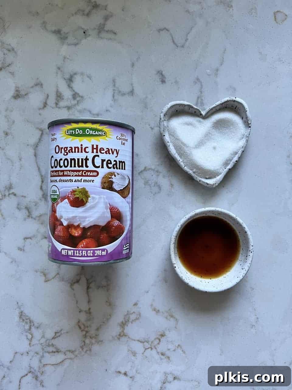 Plant-Based Whipped Topping 3 ingredients for vegan whipped cream laid out against a white marble background
