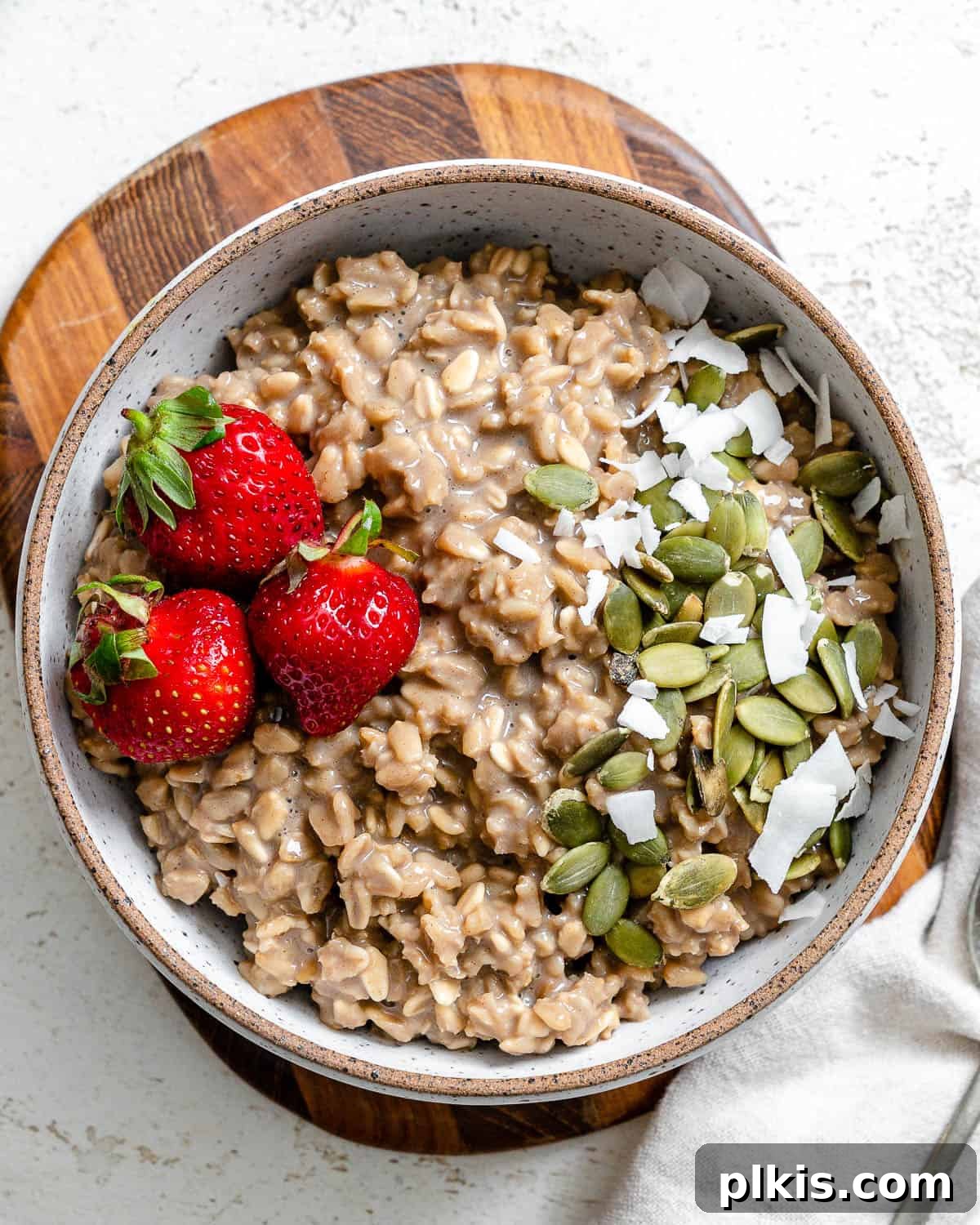 Quick Coffee Oats 2 A beautifully presented bowl of coffee oatmeal, garnished with fresh fruit and coconut flakes, resting on a light surface, ready to be enjoyed as a healthy and energizing breakfast.