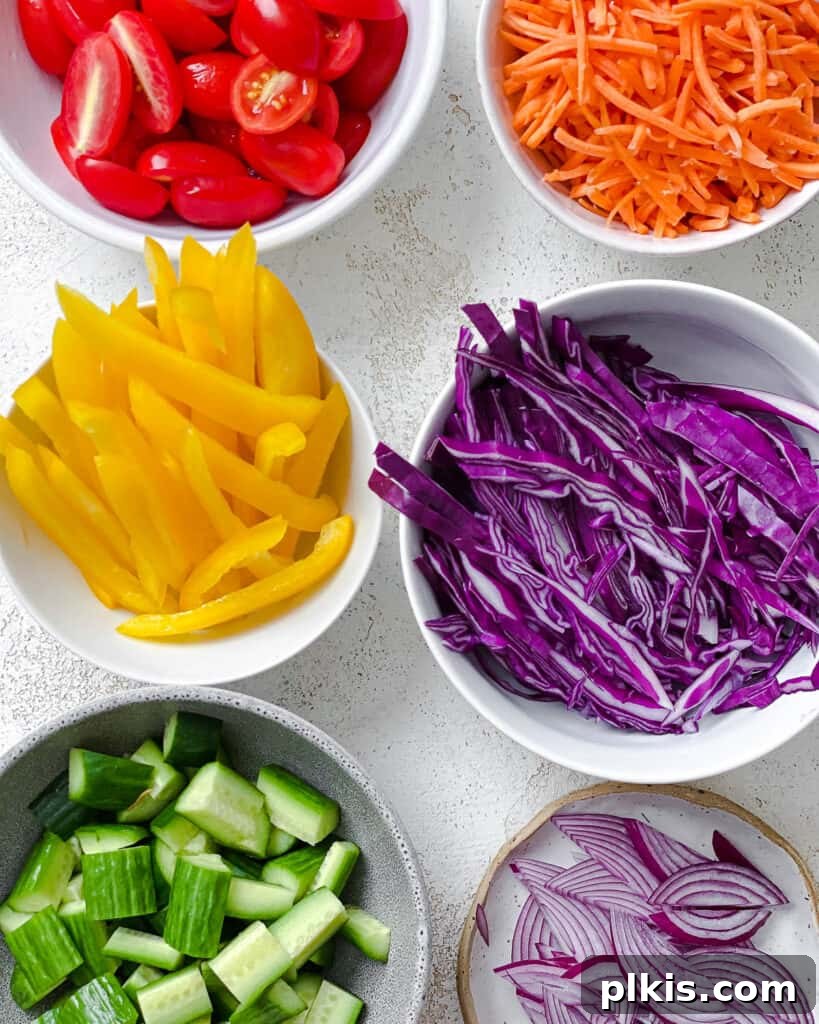 Kaleidoscope Salad 6 ingredients measured out for rainbow salad in individual bowls
