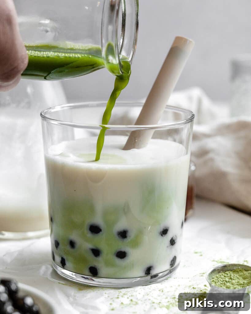 Emerald Creamy Matcha Boba 6 process shot of adding matcha powder to glass to create layered matcha boba tea