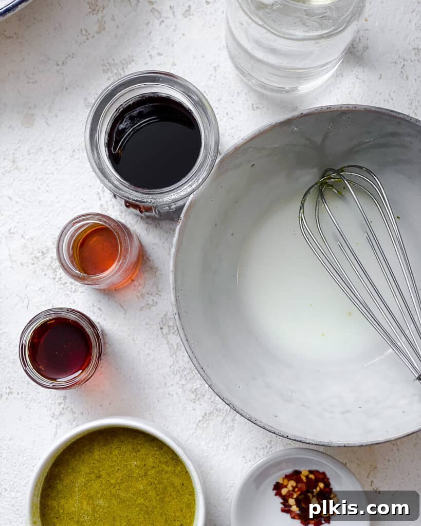 All stir-fry sauce ingredients, including soy sauce, sweetener, and vegetable broth, neatly prepared in individual containers.