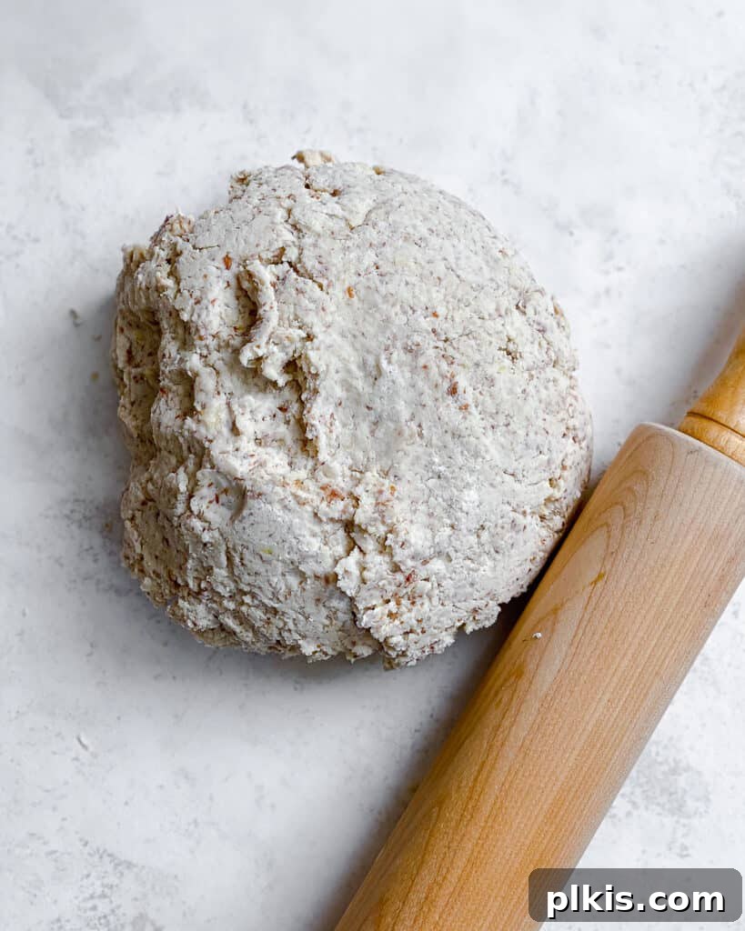 Zesty Vegan Lemon Shortbread 16 Cookie dough shaped into a ball, ready to be rolled out, with a rolling pin beside it.