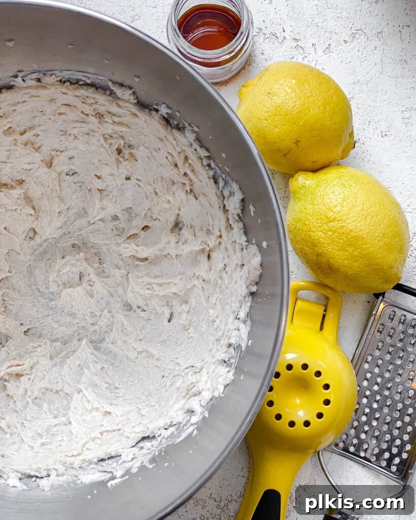 Zesty Vegan Lemon Shortbread 7 Process shot showing the blended sugar and butter mixture, light and fluffy, with fresh lemons nearby.