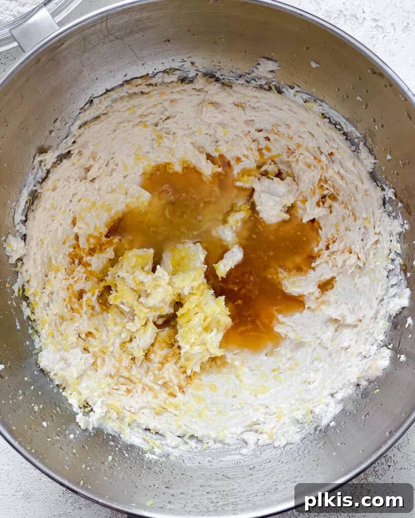 Zesty Vegan Lemon Shortbread 9 Process shot of adding additional wet ingredients like vanilla and lemon to the bowl of sugar and butter.