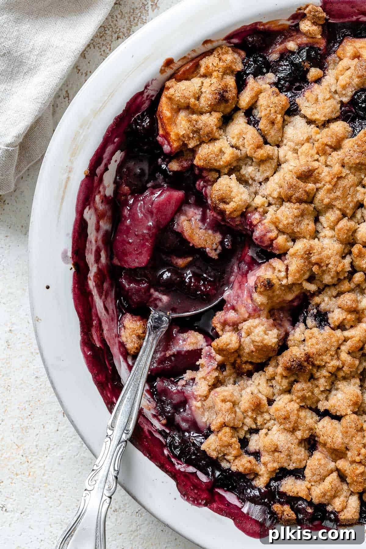 Warm Apple Blueberry Crumble 15 completed Apple and Blueberry Crumble against a light background