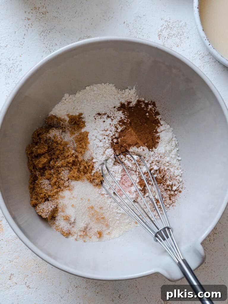 Warm Apple Blueberry Crumble 4 process shot of mixing ingredients together in a bowl with a whisk