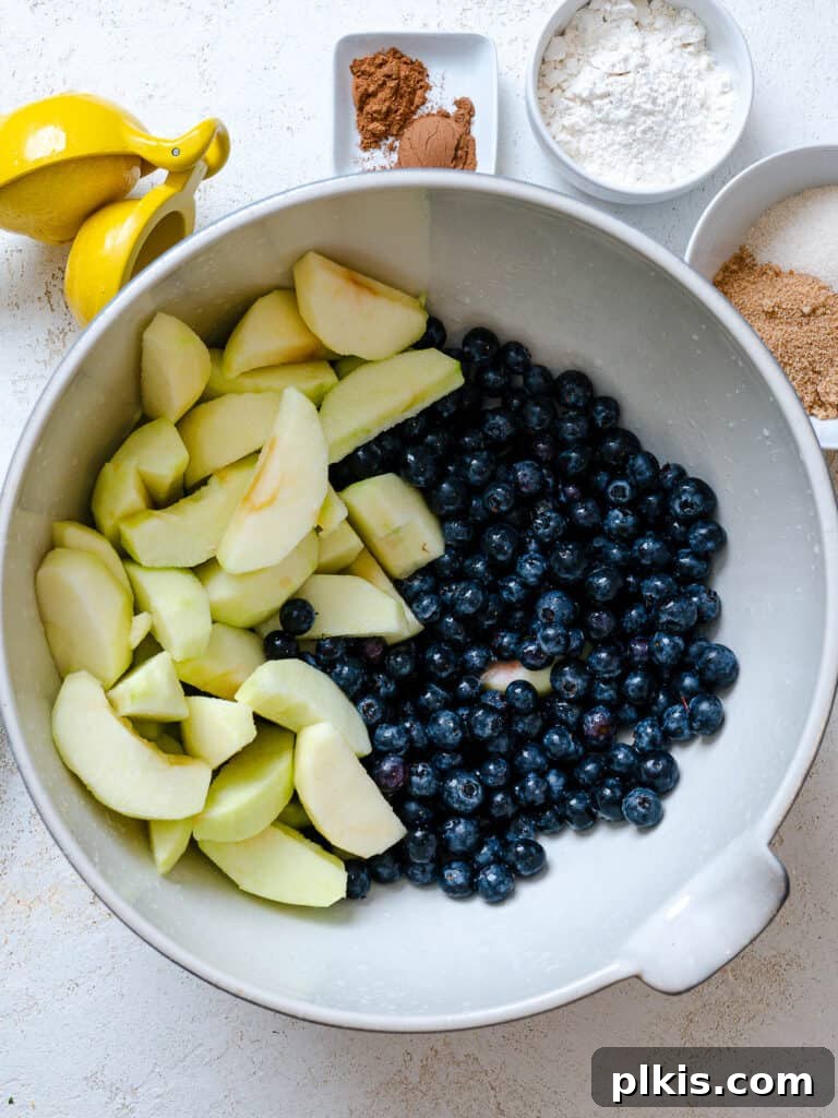 Warm Apple Blueberry Crumble 7 sliced apples and blueberries in white bowl