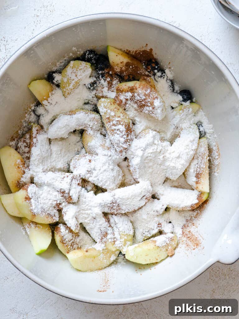 Warm Apple Blueberry Crumble 8 process shot of sugar added to bwol of fruit