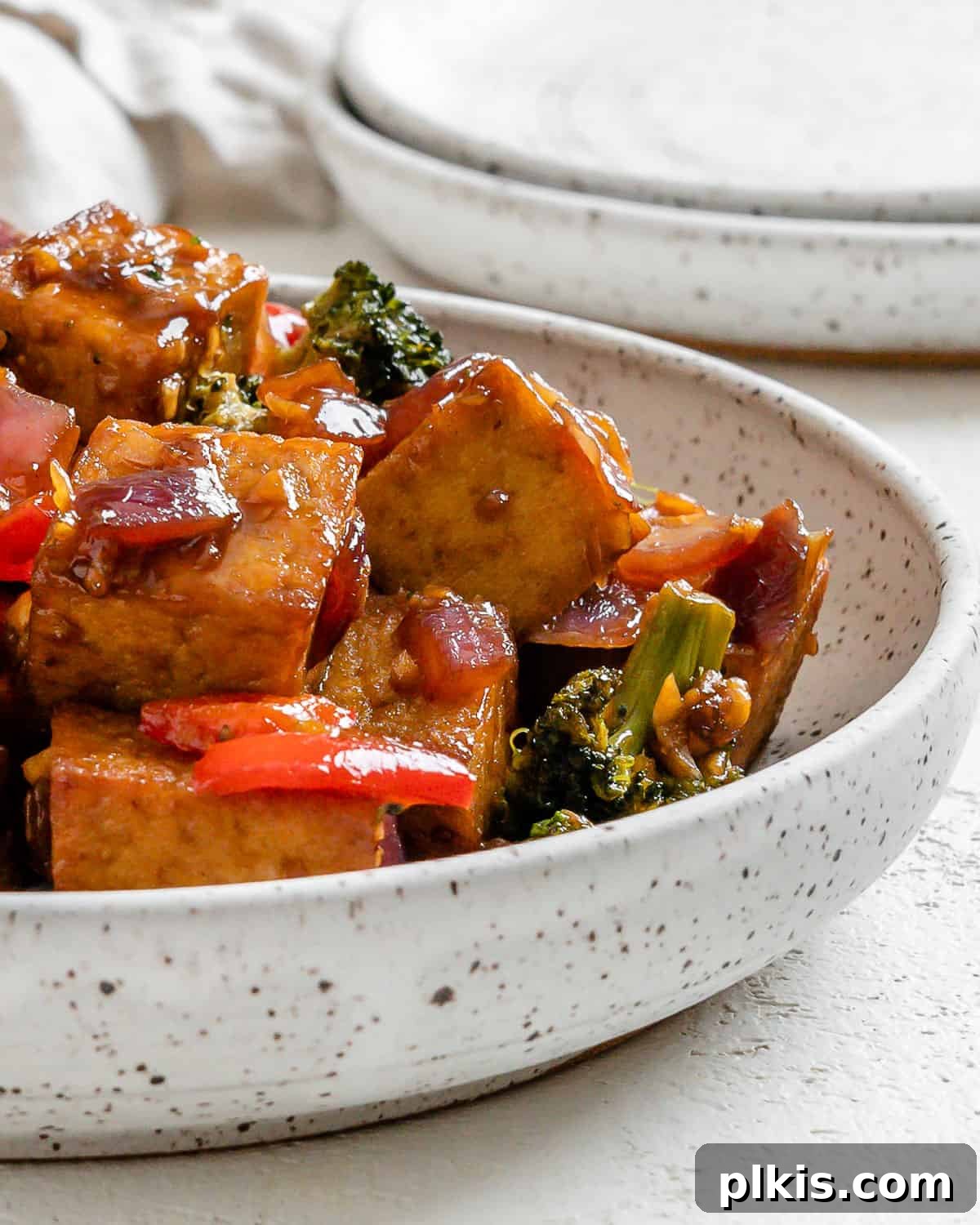 Speedy Teriyaki Tofu Bowl 8 Completed Vegan Teriyaki Tofu Stir Fry plated on a white bowl against a light surface, ready to be enjoyed