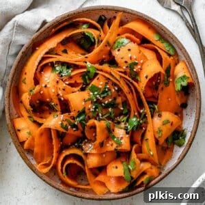 completed Raw Carrot Salad plated against a white background