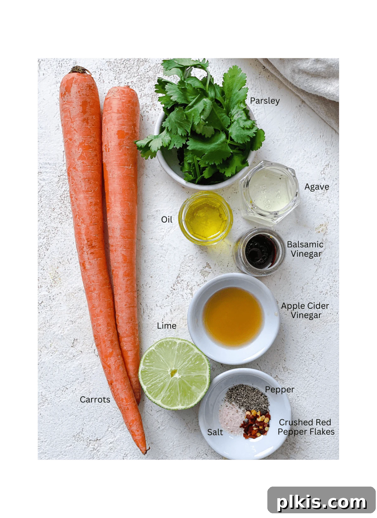 Vibrant Carrot Salad 3 ingredients for Raw Carrot Salad measured out against a white surface