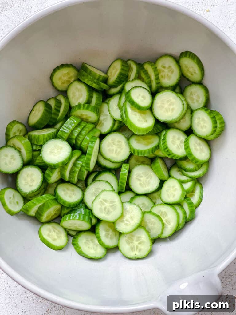Sassy Cucumber Slaw 4 Sliced cucumbers in a white bowl, ready for dressing.