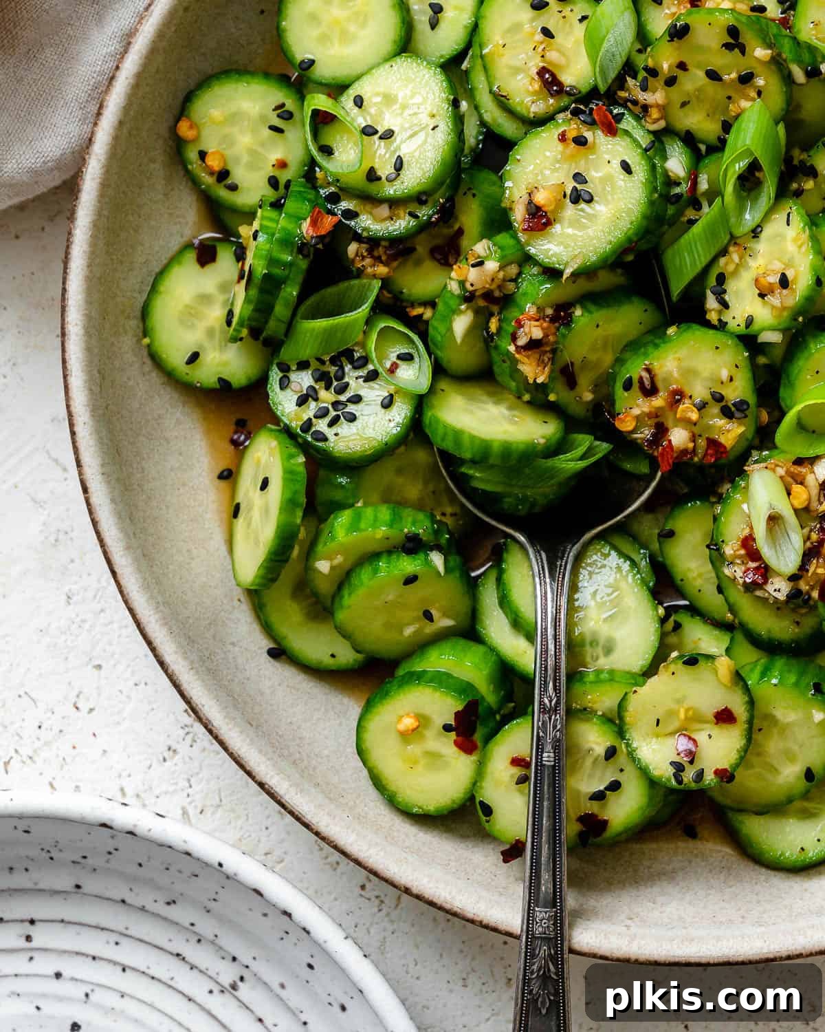 Sassy Cucumber Slaw 7 A final shot of the completed Spicy Asian Cucumber Salad in a white bowl, ready for serving, against a soft background.