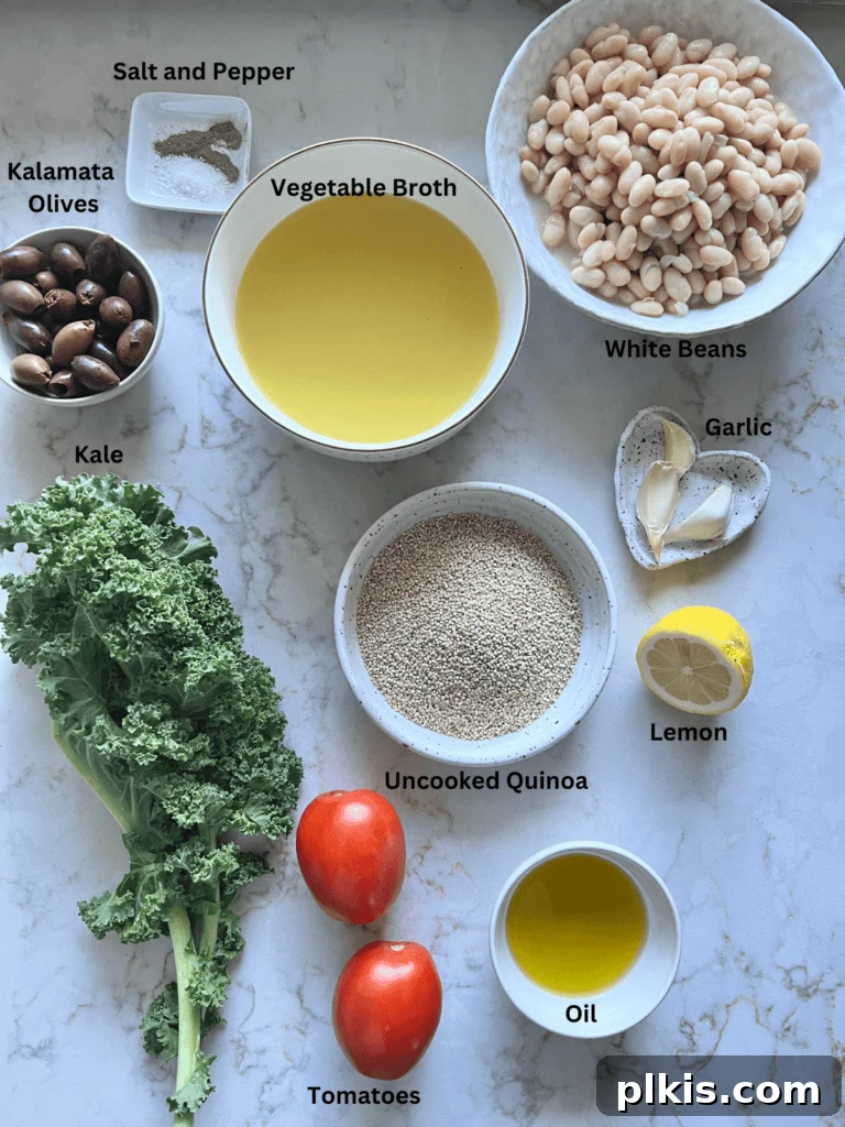 Zesty Mediterranean Vegan Quinoa 3 A collection of measured ingredients for Lemon Garlic Quinoa laid out on a white marble surface, including uncooked quinoa, kale, garlic, lemon, and white beans.