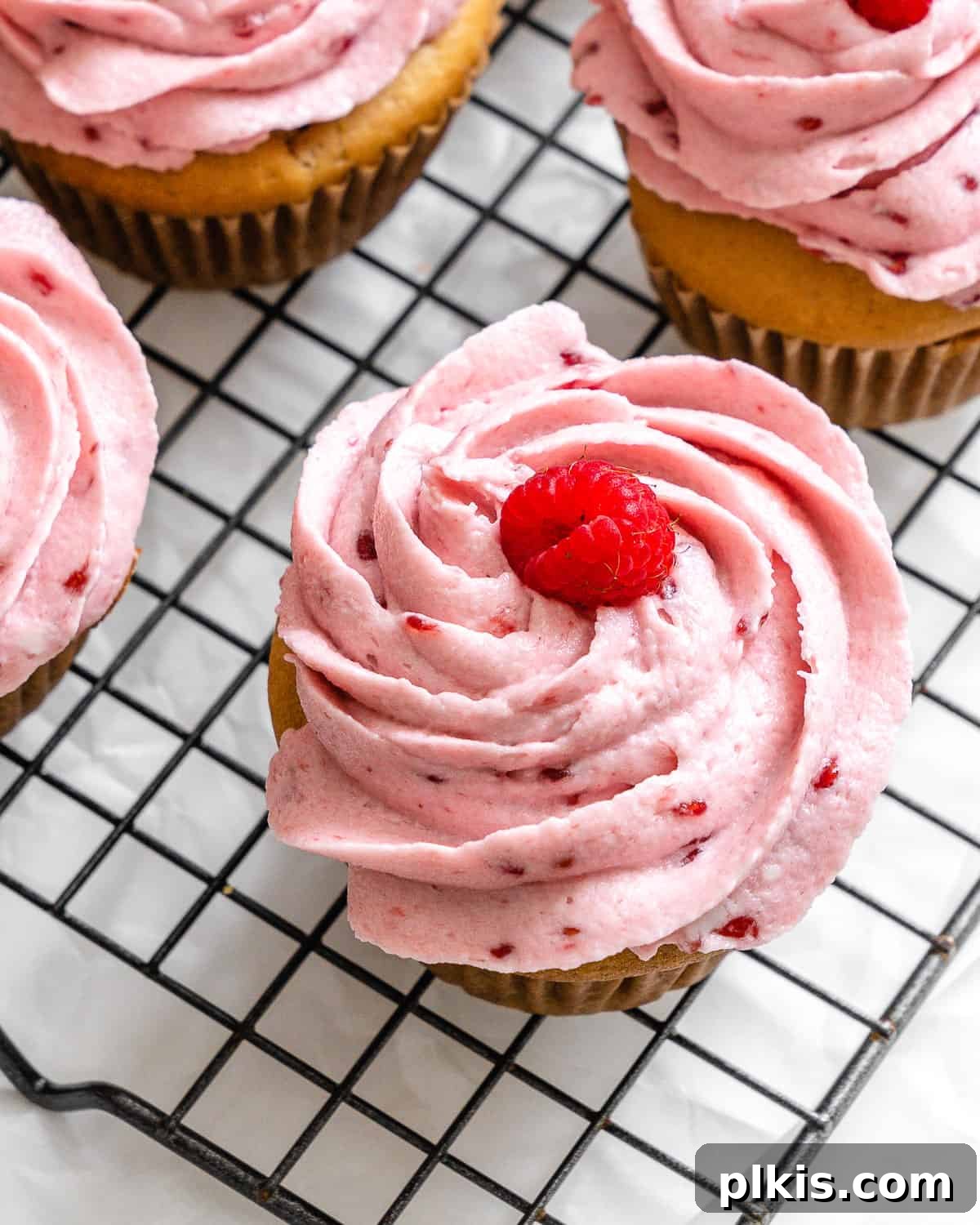 Simple Raspberry Cupcakes Your Way 12 completed raspberry cupcakes on wire rack