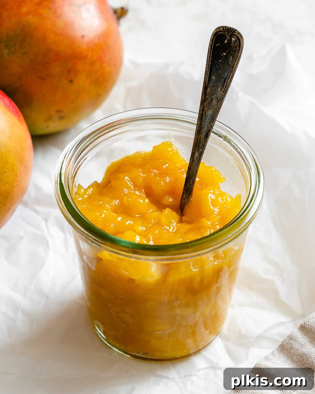 Versatile 3-Ingredient Mango Topping 2 A jar of beautifully prepared mango compote set against a soft, light background, ready to be enjoyed.