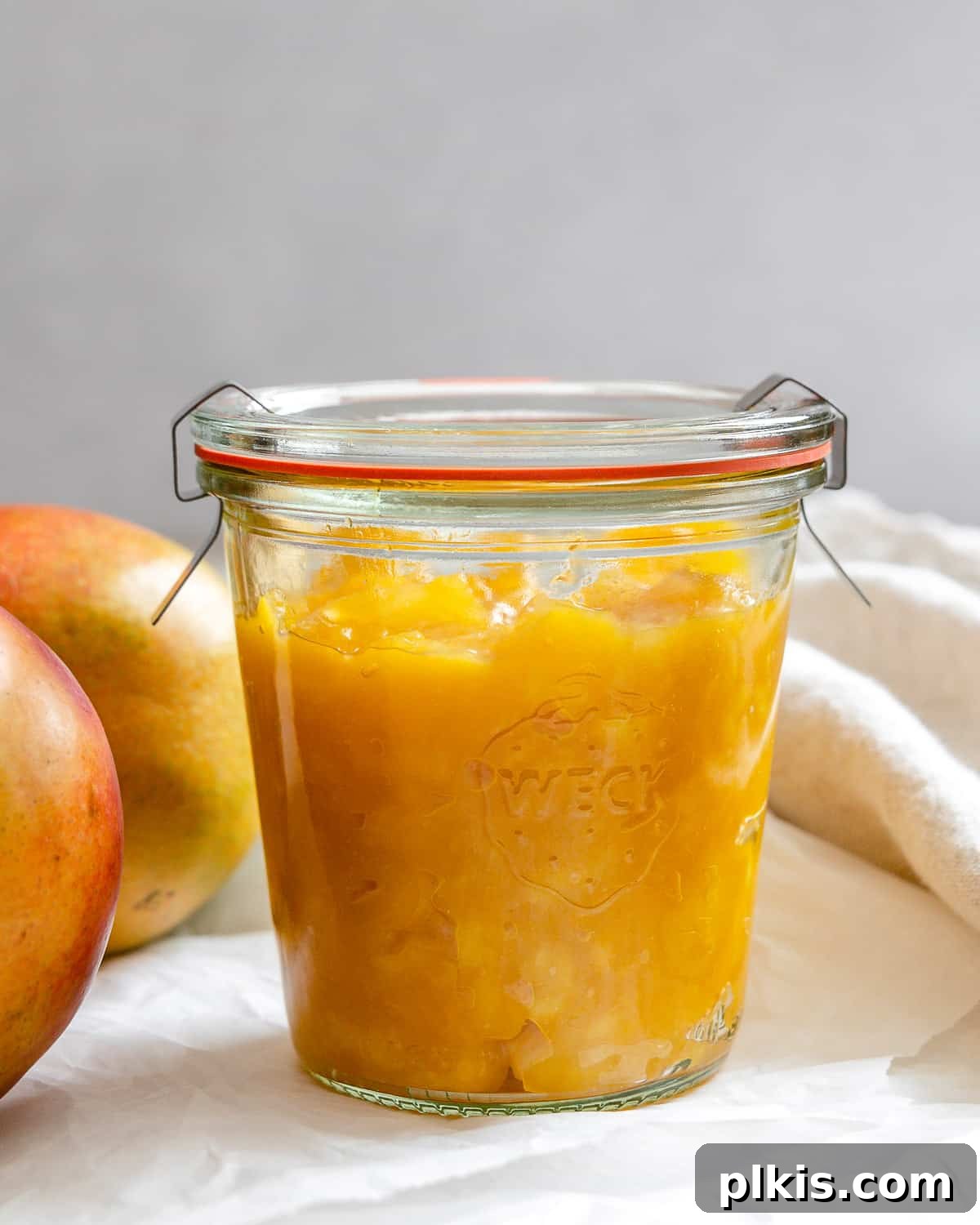 Versatile 3-Ingredient Mango Topping 11 Another appealing shot of the completed mango compote in a jar, presented beautifully against a light background, ready for serving.