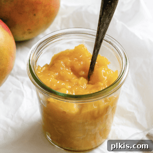 completed mango compote in a jar against a light background