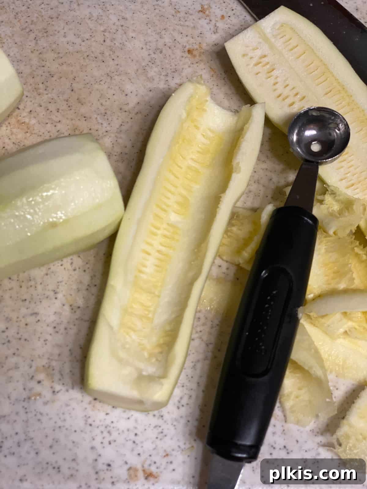 Zucchini Apple Pie Surprise 4 Process shot of hollowing out zucchini with a melon baller, preparing it for the mock apple pie filling.