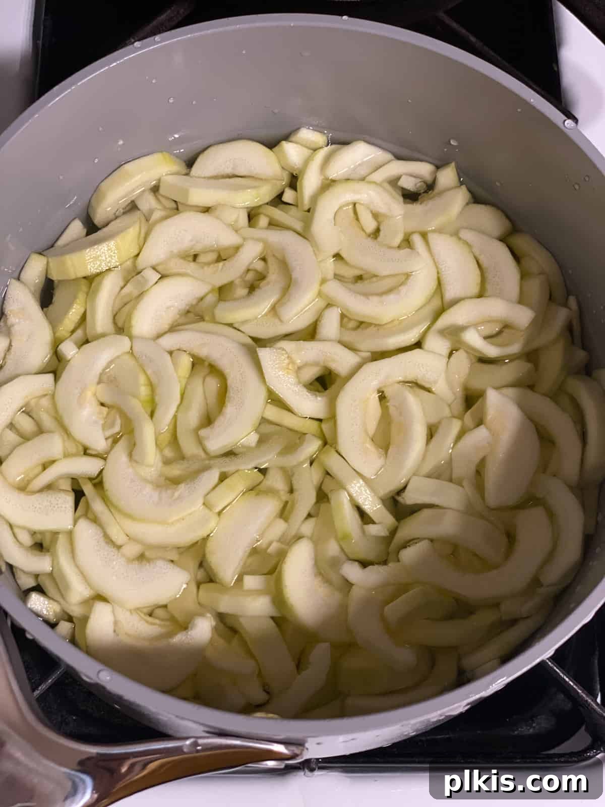 Zucchini Apple Pie Surprise 5 Process shot of cooking zucchini in a large pot of boiling water, ensuring it reaches a tender-crisp texture for the pie filling.