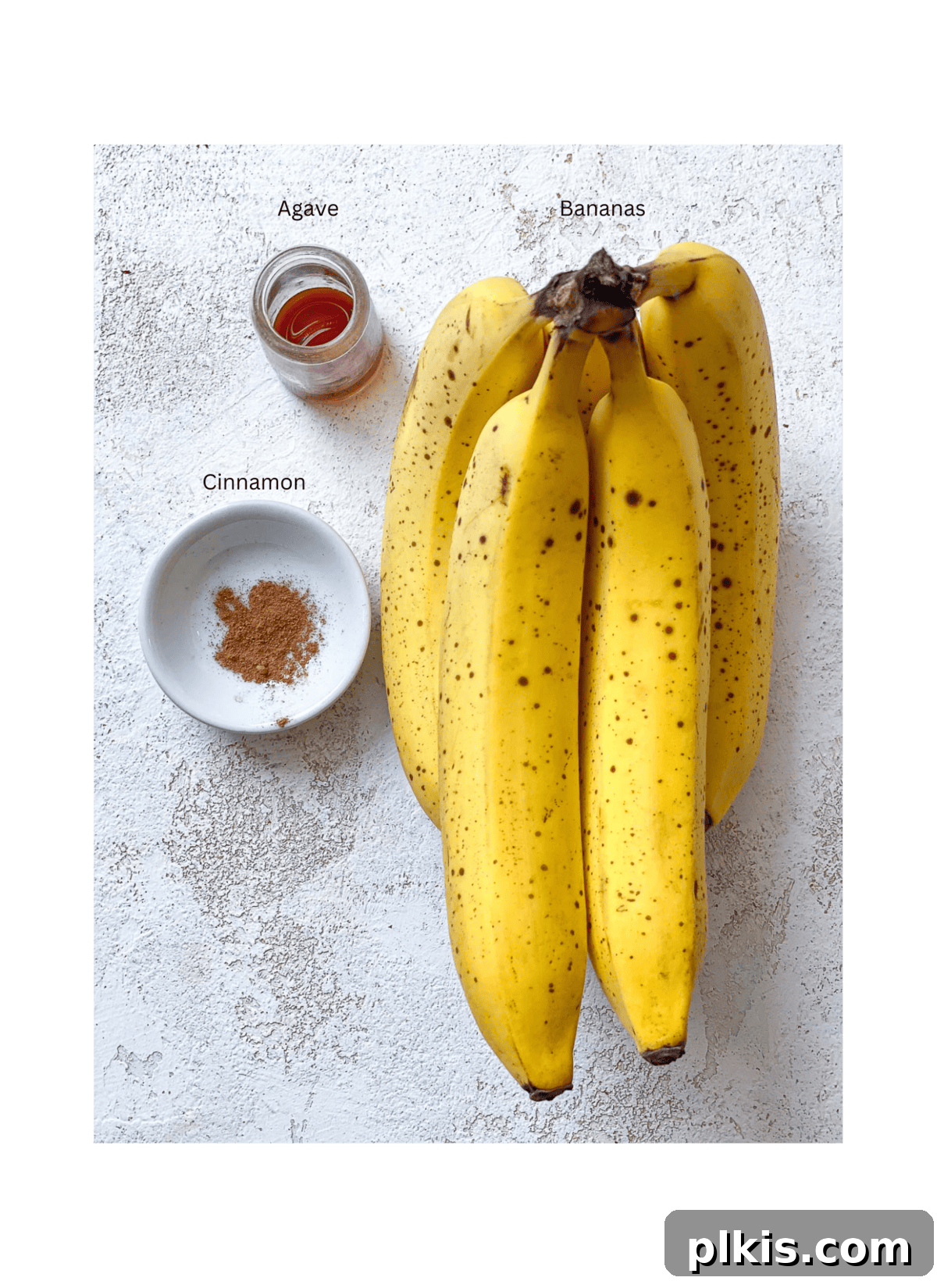 Naturally Sweet Banana Pops 3 A selection of ingredients for healthy banana popsicles, including ripe bananas, vanilla extract, and optional sweeteners, neatly arranged on a white surface.