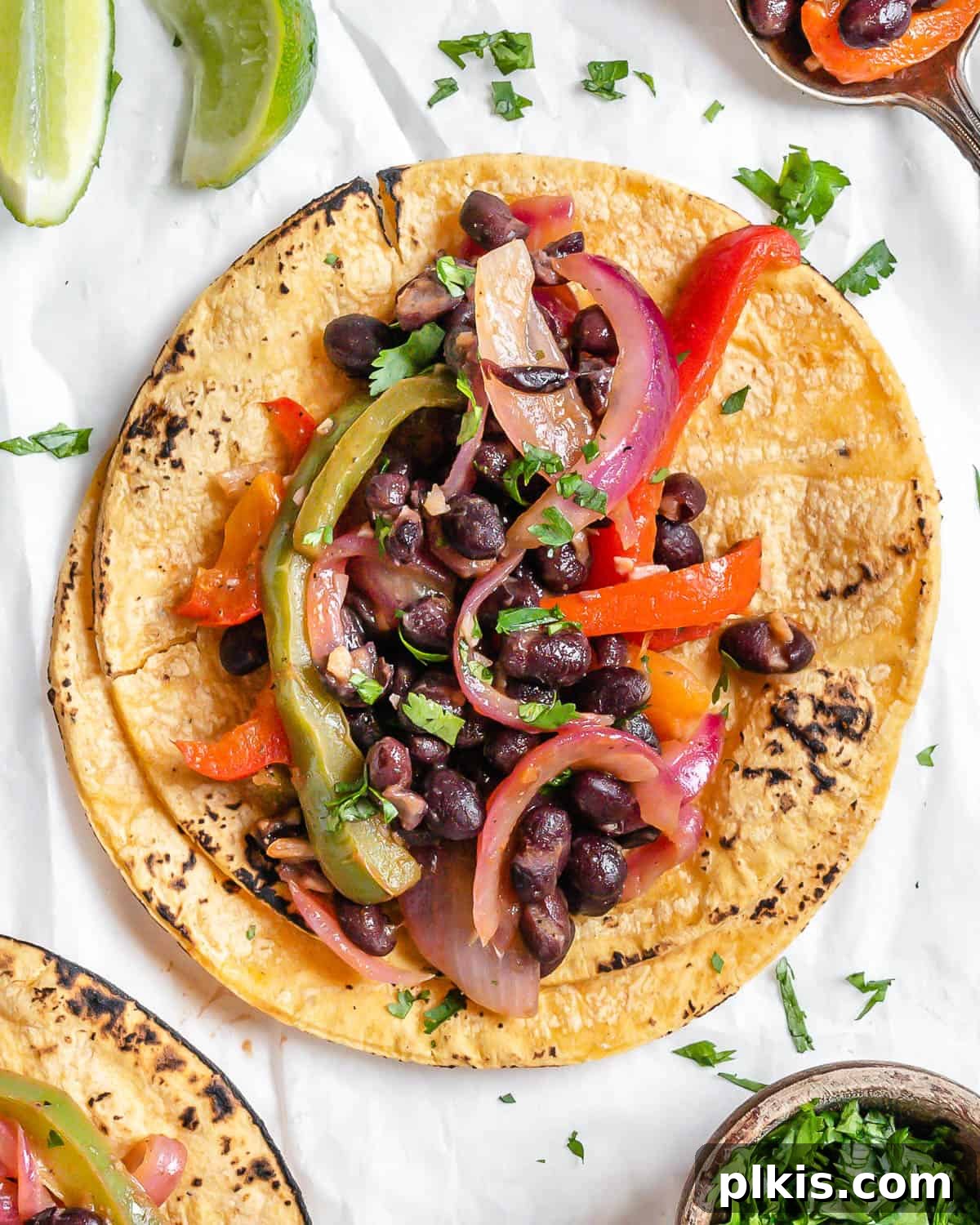 Sizzling Veggie Tacos 2 completed Vegan Fajita Tacos against a white surface