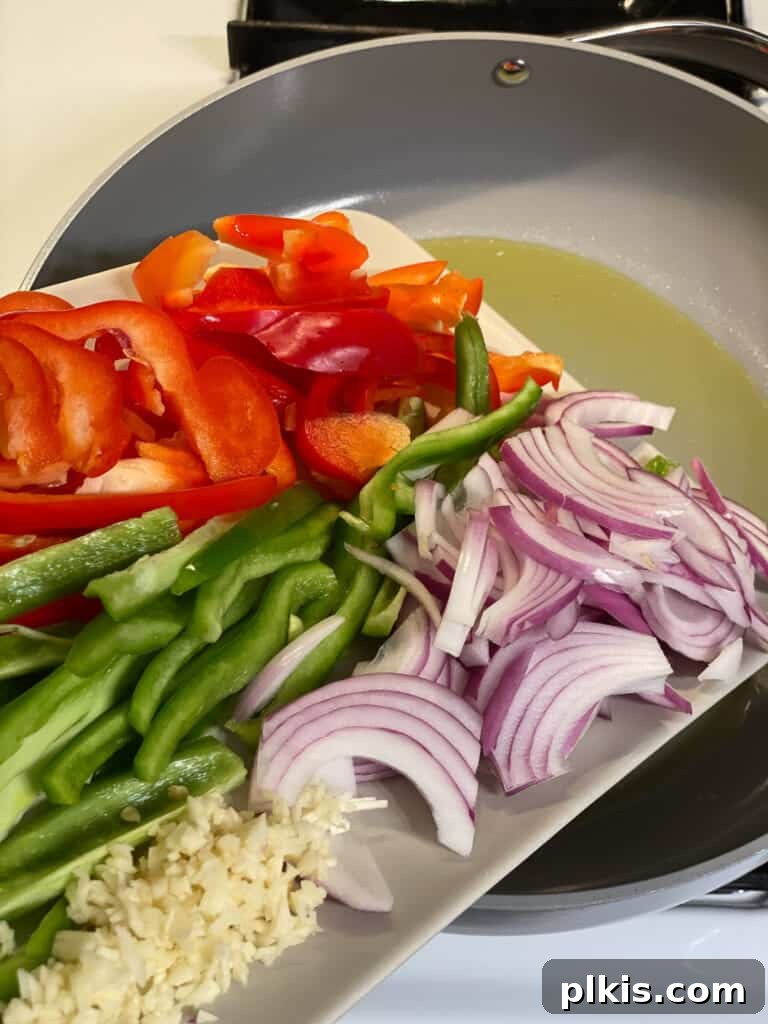 Sizzling Veggie Tacos 4 sliced vegetables for Vegan Fajita Tacos being poured into a pan