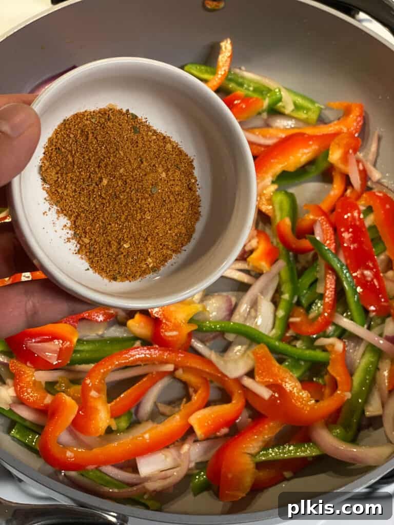 Sizzling Veggie Tacos 5 process of seasonings being poured into pan of veggies