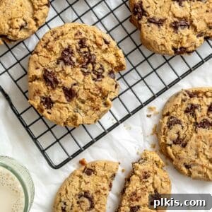 Completed dairy-free chocolate chip cookies on a wire rack and a white surface.
