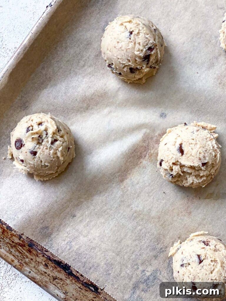 Moo-Free Chocolate Chip Wonders 7 Process shot showing pre-baked balls of dairy-free cookie dough neatly arranged on a baking tray, ready for the oven.