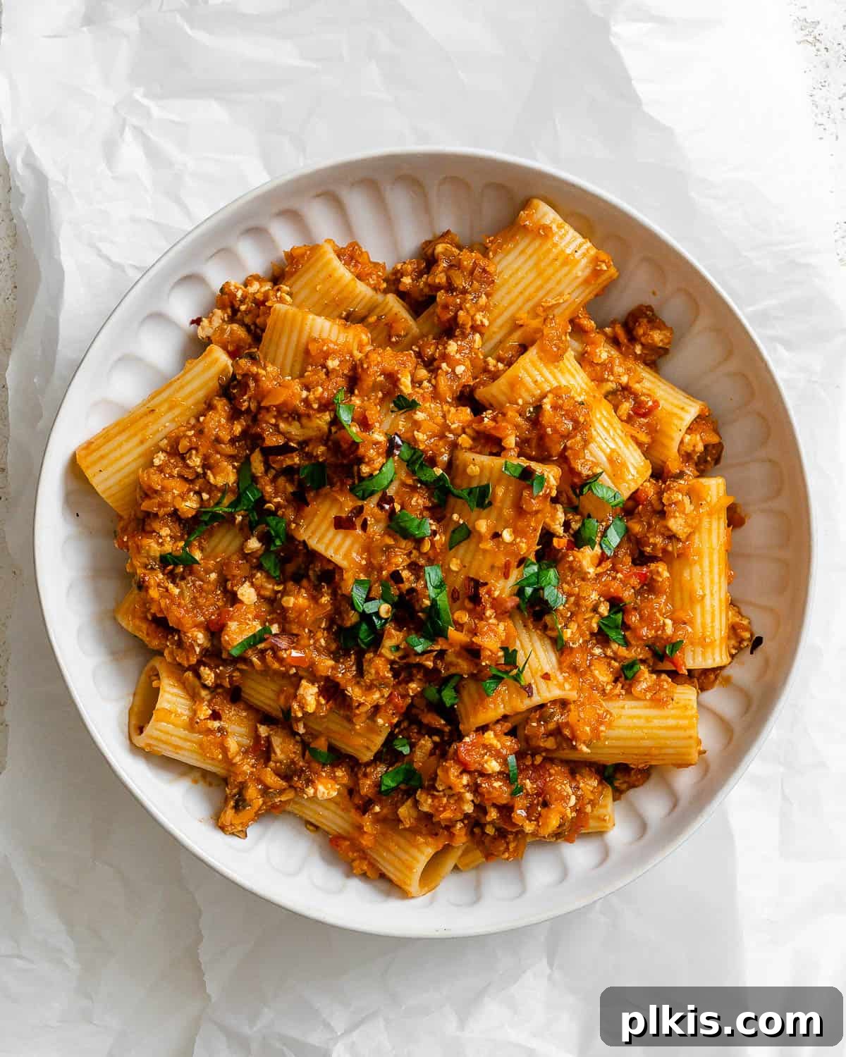 Hearty Vegan Ragu 2 A vibrant Tofu Bolognese dish, beautifully plated on a white plate, showcasing its rich texture and appetizing appeal.