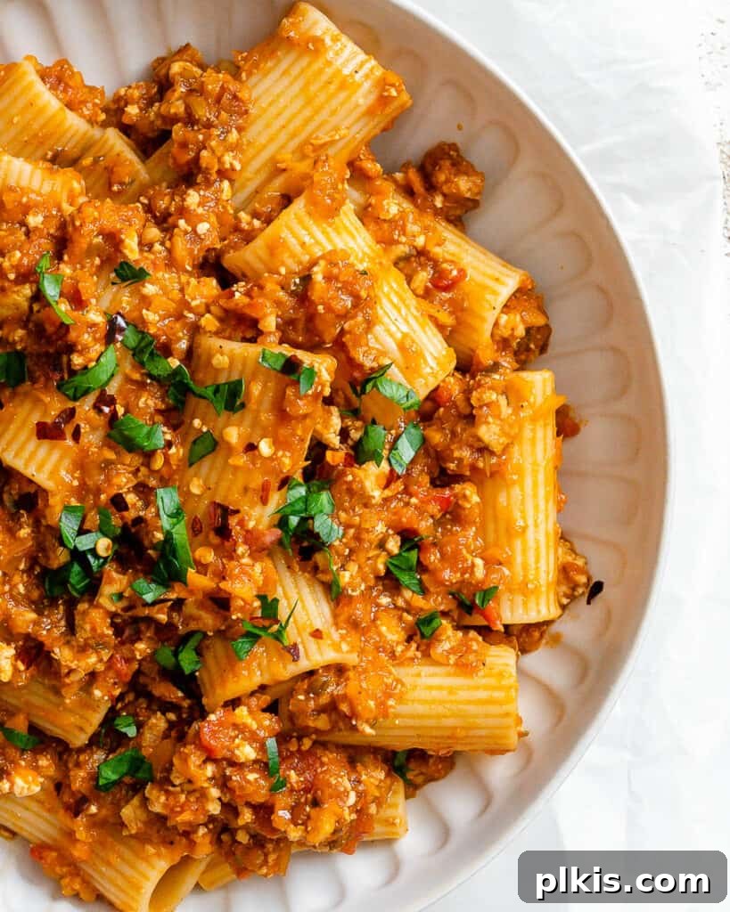 Hearty Vegan Ragu 16 A beautifully plated bowl of Tofu Bolognese, garnished and ready to be enjoyed, showing its rich texture.
