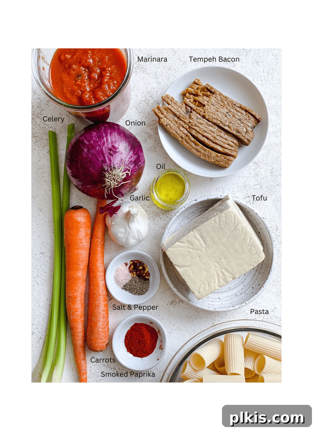 Hearty Vegan Ragu 3 A carefully arranged selection of fresh ingredients for Tofu Bolognese, measured out against a clean white surface, highlighting quality and freshness.
