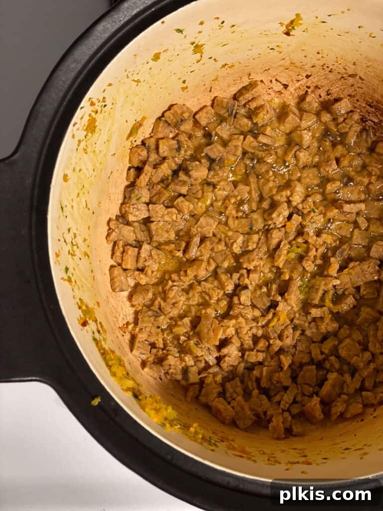 Hearty Vegan Ragu 9 Process shot of tempeh cooking in the pot, developing a browned and slightly crispy texture.