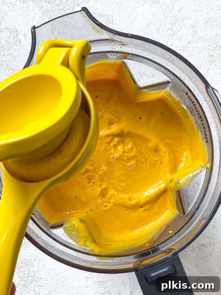 Simple Golden Carrot Sauce 15 process shot of adding lemon juice to blender