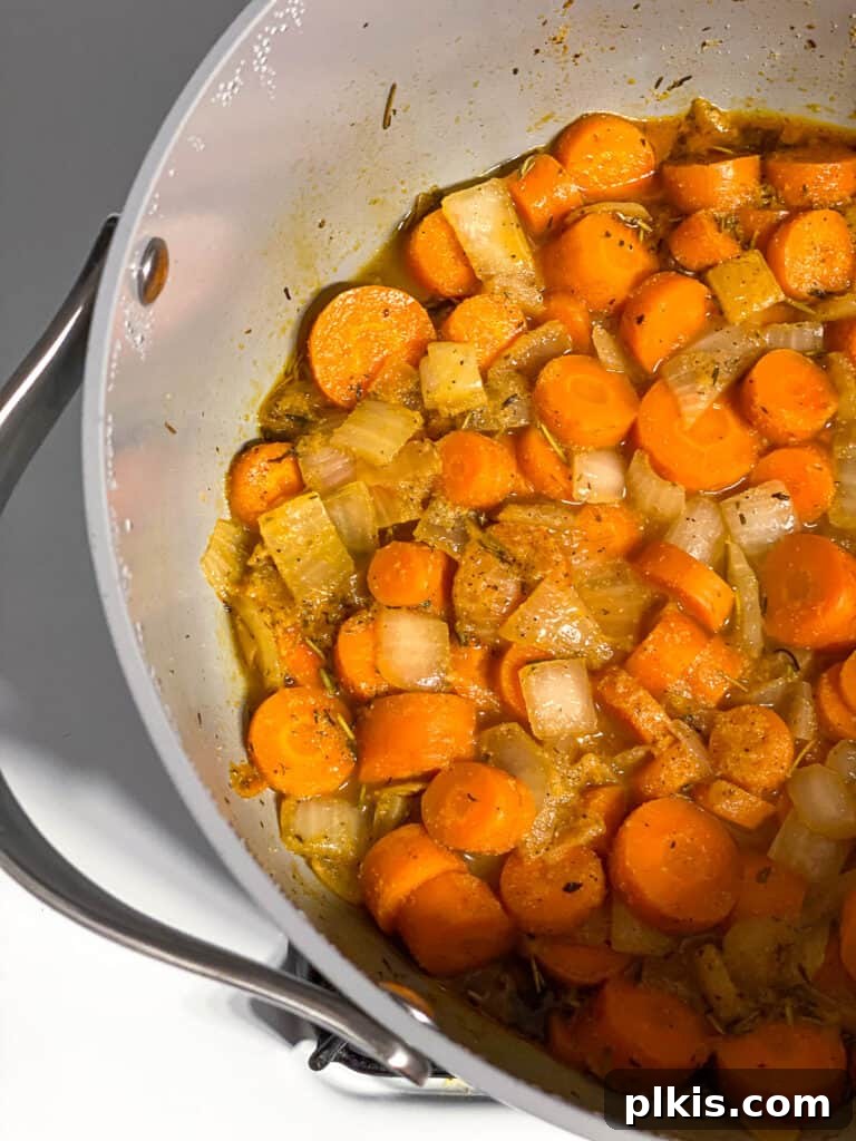 Simple Golden Carrot Sauce 9 process shot of letting carrot sauce cook in pan