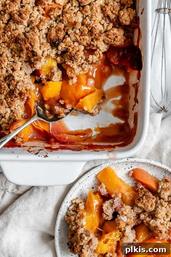 Effortless Vegan Peach Cobbler 10 Another close-up of the completed Easy Vegan Peach Cobbler in its baking dish, showcasing the golden topping and bubbling fruit.