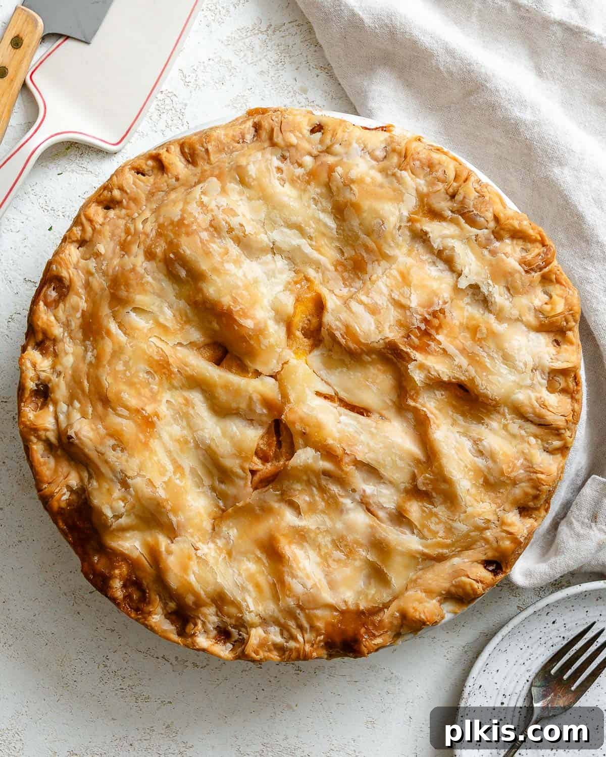 Golden Peach Mango Delights 2 A beautifully baked Easy Peach Mango Pie, or mini hand pies, presented on a pristine white surface, highlighting its golden crust and inviting fruit filling.