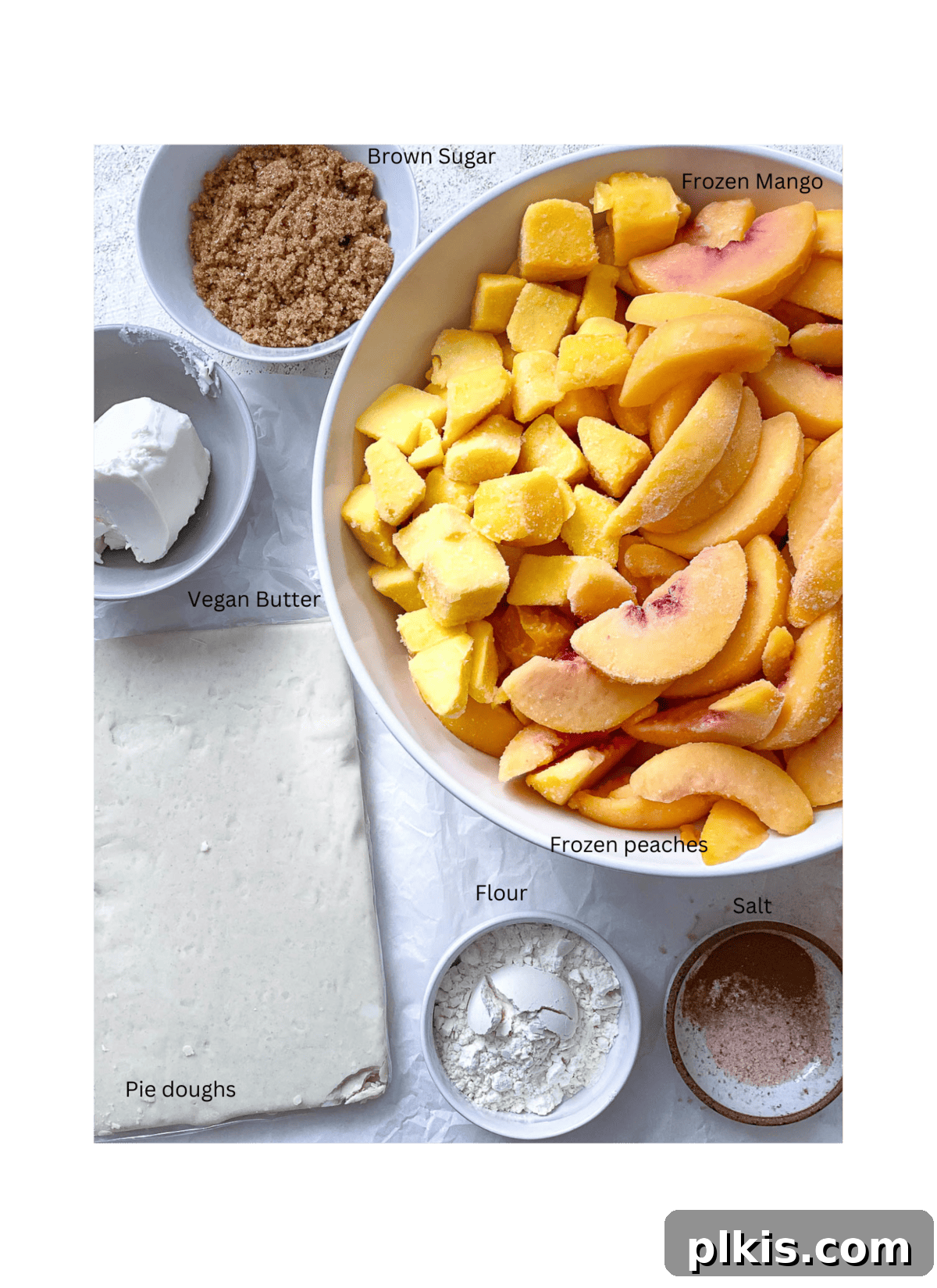 Golden Peach Mango Delights 3 All the measured ingredients for Easy Peach Mango Pie or Hand Pies laid out neatly on a white surface, ready for preparation.