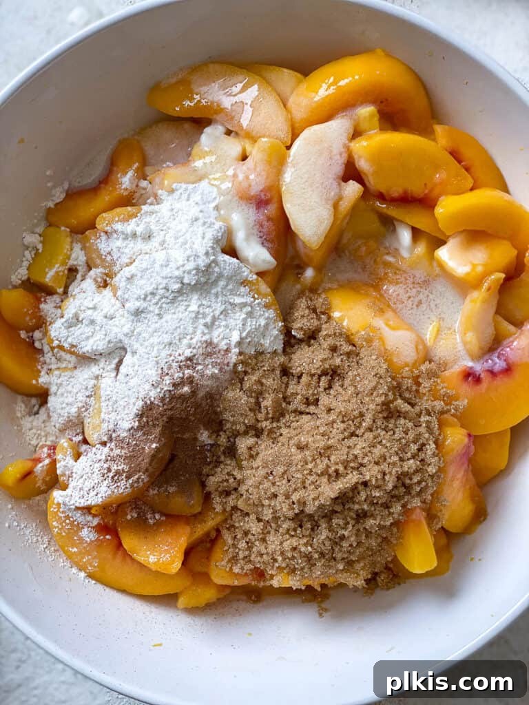 Golden Peach Mango Delights 5 A process shot showing the fruit and dry ingredients being combined in a bowl for the Easy Peach Mango Pie filling.