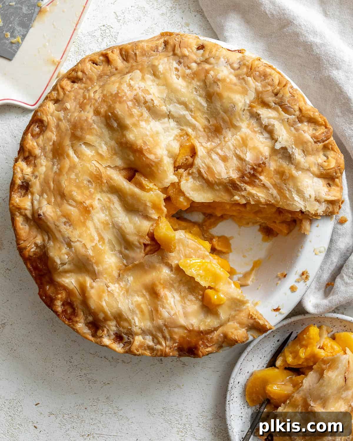 Golden Peach Mango Delights 8 A close-up shot of the perfectly baked Easy Peach Mango Pie or Hand Pies, showcasing its golden-brown crust and juicy filling.